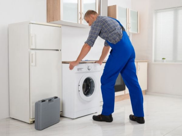 Technician conducting sustainable appliance maintenance
