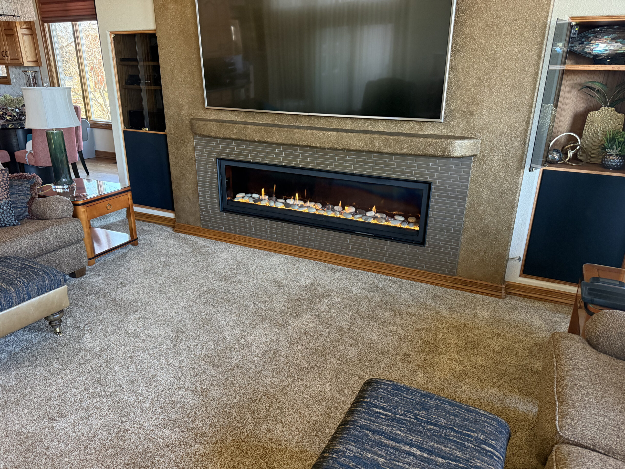 Operating linear gas fireplace in a finished living room