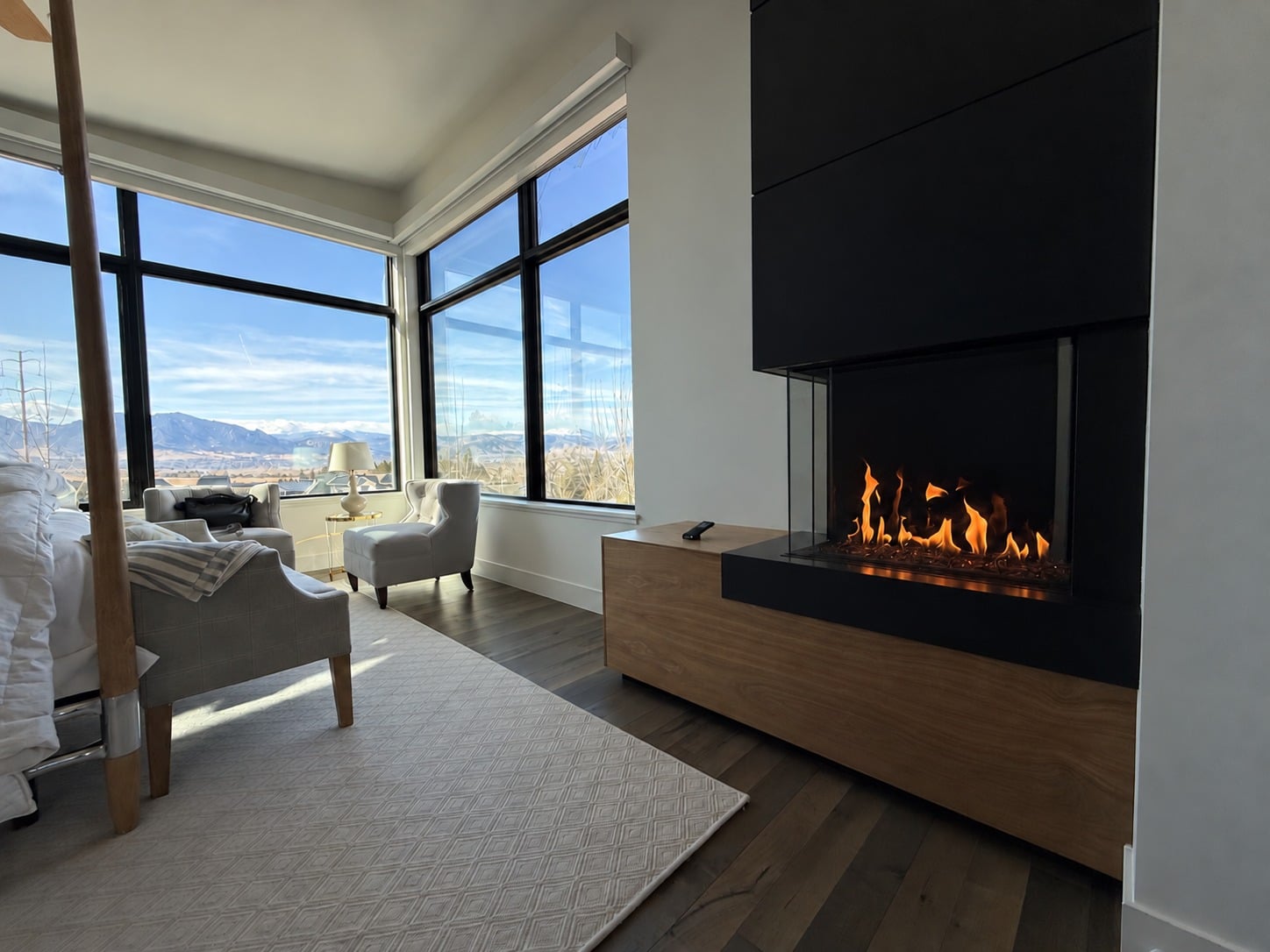 Modern corner gas fireplace with visible flames in a bright living room