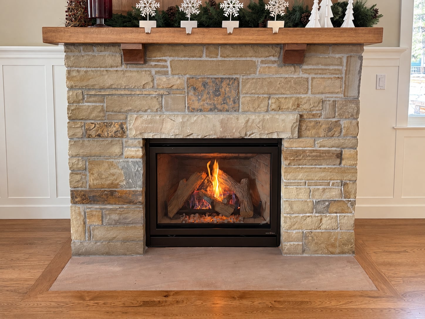 Operating gas fireplace with a stone surround and wood mantel